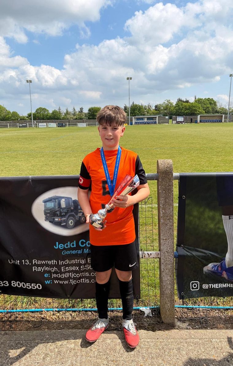 Carter holding his winner's trophy after captaining his team in the final